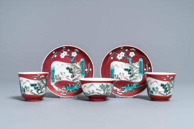 A Chinese famille rose ruby-ground teapot, three cups and two saucers, Yongzheng