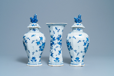 A Dutch Delft blue and white three-piece vase garniture with a dog, 18th C.