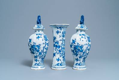 A Dutch Delft blue and white three-piece vase garniture with a dog, 18th C.