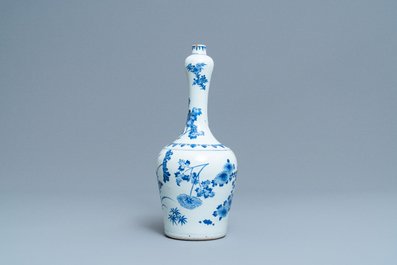 A Chinese blue and white bottle vase with floral design, Transitional period