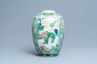 A large Chinese famille verte 'mythical beasts' jar with wooden cover, Kangxi