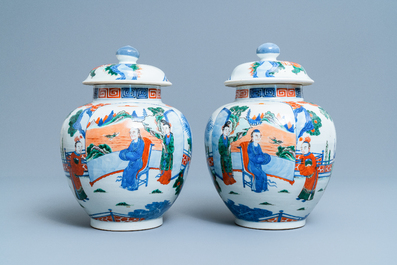 A pair of Chinese wucai vases and covers, Kangxi mark, 19th C.