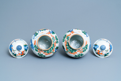 A pair of Chinese wucai vases and covers, Kangxi mark, 19th C.