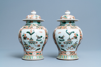 A pair of Chinese famille verte vases and covers, Kangxi mark, 19th C.