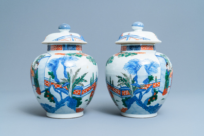 A pair of Chinese wucai vases and covers, Kangxi mark, 19th C.