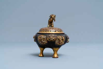 A Chinese lacquered and parcel-gilt bronze tripod censer and cover, Ming