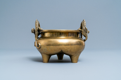 A Chinese bronze chilong-handled tripod censer, seal mark, 17/18th C.