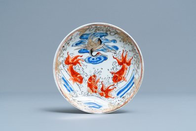 A Chinese 'crane and carps' cup and saucer, Yongzheng
