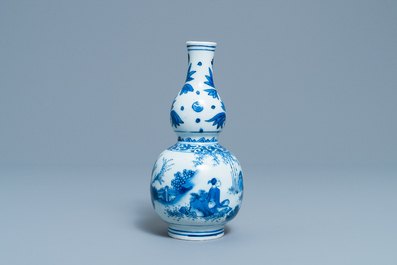 A Chinese blue and white double gourd vase with figures in a landscape, Transitional period