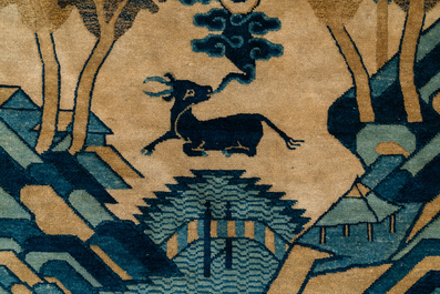 A rectangular Chinese Beijing silk carpet with a deer in a landscape, 19th C.