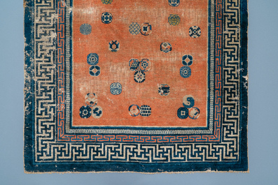A rectangular Chinese hand-knotted wool carpet with brocade balls, 19th C.