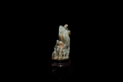 A Chinese mottled celadon and brown jade 'Eight horses of Mu Wang' carving, Qing