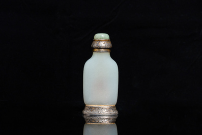 A Chinese white jade snuff bottle and two green jade carvings, 17th C. and later