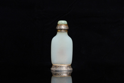 A Chinese white jade snuff bottle and two green jade carvings, 17th C. and later