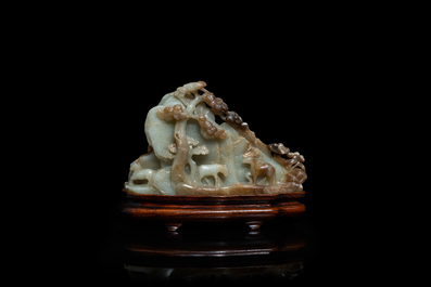 A Chinese mottled celadon and brown jade 'Eight horses of Mu Wang' carving, Qing