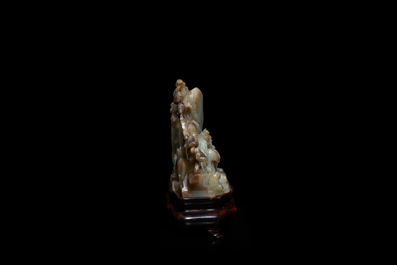 A Chinese mottled celadon and brown jade 'Eight horses of Mu Wang' carving, Qing