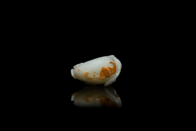 A Chinese pale celadon and russet jade model of a peach, Ming