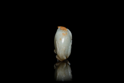 A Chinese pale celadon and russet jade model of a peach, Ming