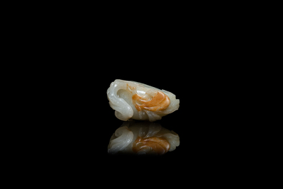 A Chinese pale celadon and russet jade model of a peach, Ming