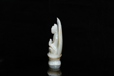 A Chinese pale celadon jade figure of Guanyin on a lotus throne, 19/20th C.