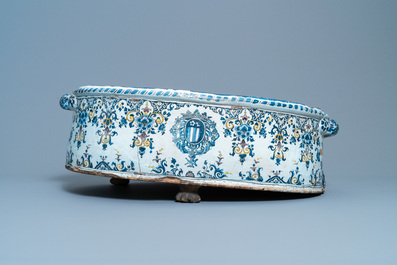 A large oval polychrome French faience armorial basin, Rouen or Paris, 18th C.