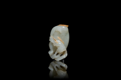 A Chinese pale celadon and russet jade model of a peach, Ming