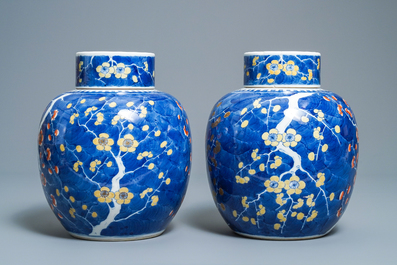 A pair of Chinese polychrome 'prunus on cracked ice' jars and covers, 19th C.