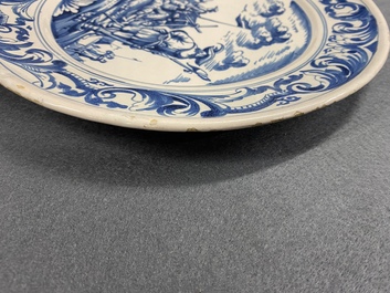 A Dutch Delftware blue and white dish with soldiers at camp, Makkum, dated 1764