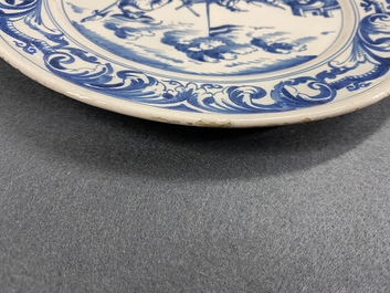 A Dutch Delftware blue and white dish with soldiers at camp, Makkum, dated 1764