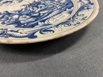 A Dutch Delftware blue and white dish with soldiers at camp, Makkum, dated 1764
