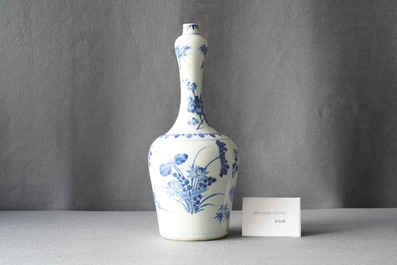 A Chinese blue and white bottle vase with floral design, Transitional period