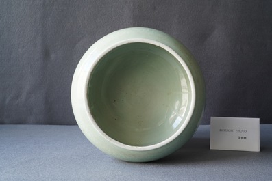 Een Chinese monochrome celadon driepotige wierookbrander met onderglazuur floraal decor, Kangxi