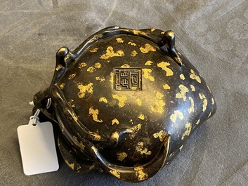 A Chinese gold-splashed bronze peach-form censer, Xuande mark, 18th C.