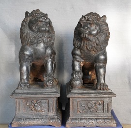 A pair of large Chinese cast iron models of lions, Ming mark and of the period