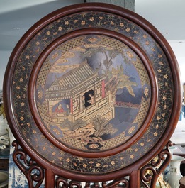 A massive Chinese carved wooden screen with a round famille verte plaque and polychrome lacquer, 19th C.