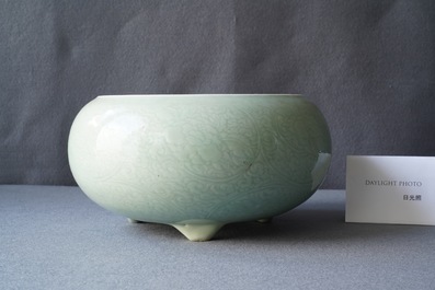 A Chinese celadon-glazed tripod censer with incised underglaze design, Kangxi