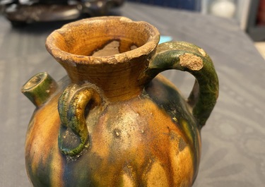 A Chinese sancai ewer and a celadon-glazed bottle vase, Tang and Song