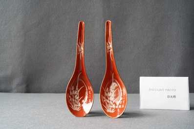 A pair of Chinese reverse-decorated iron red spoons, 19th C.