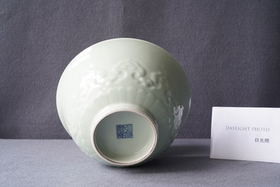 A Chinese moulded monochrome celadon bowl with incised design, Qianlong mark, 19th C.