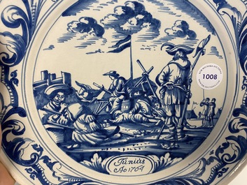 A Dutch Delftware blue and white dish with soldiers at camp, Makkum, dated 1764