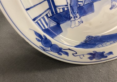 A Chinese blue and white dish with two figures in a garden, Transitional period