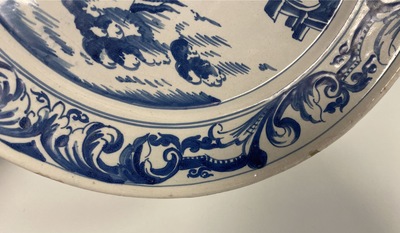 A Dutch Delftware blue and white dish with soldiers at camp, Makkum, dated 1764