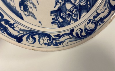 A Dutch Delftware blue and white dish with soldiers at camp, Makkum, dated 1764