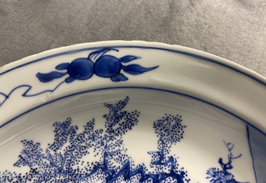 A Chinese blue and white dish with two figures in a garden, Transitional period