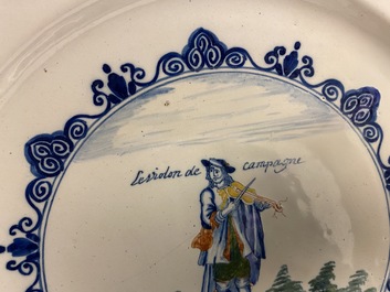 A polychrome Dutch Delft charger with a violinist, 1st half 18th C.