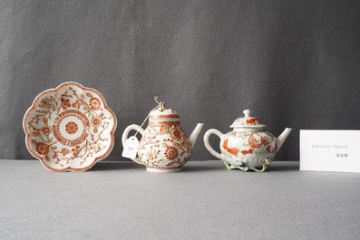 Two Chinese iron red and gilt relief-decorated teapots and one stand, Kangxi/Yongzheng