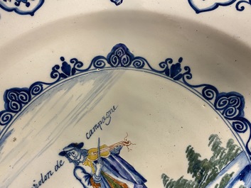 A polychrome Dutch Delft charger with a violinist, 1st half 18th C.