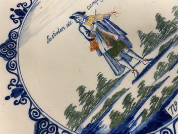 A polychrome Dutch Delft charger with a violinist, 1st half 18th C.