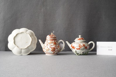 Two Chinese iron red and gilt relief-decorated teapots and one stand, Kangxi/Yongzheng