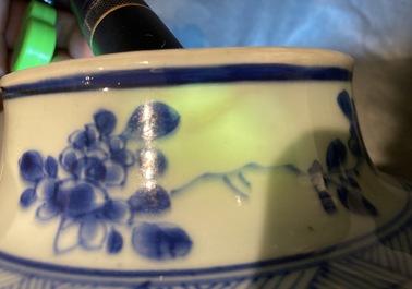 A pair of Chinese blue and white baluster vases and covers with birds in a rocky setting, Kangxi